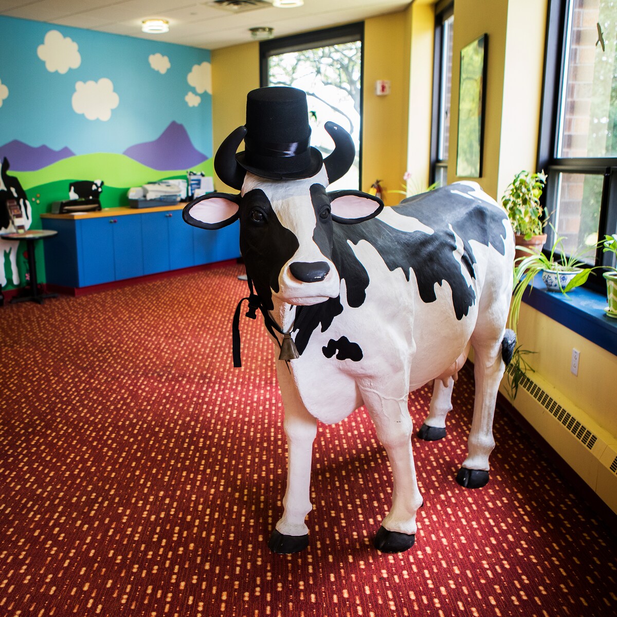 Life-sized fake cow at Ben & Jerry's offices, wearing a top hat