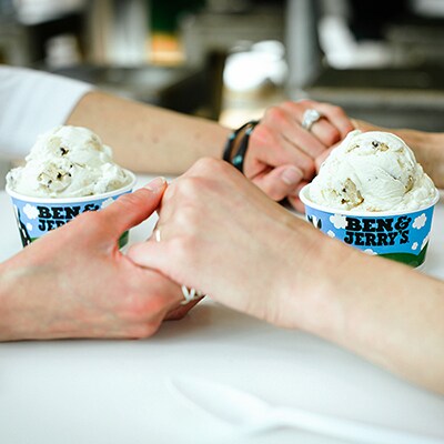 Couple holding hands at a Ben & Jerry's ice cream shop.