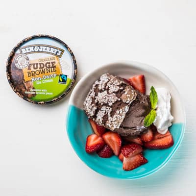 A plate with a piece of Vegan Chocolate Strawberry Shortcake and ice cream