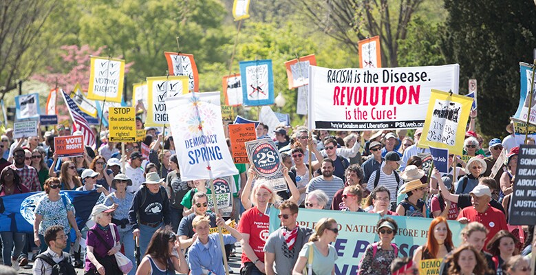 crowd of people with signs