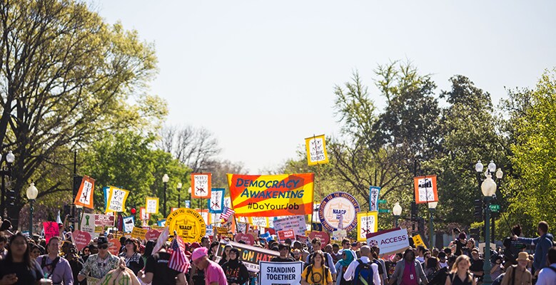 crowd of people with signs