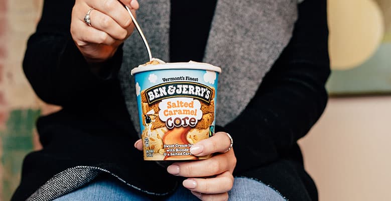 Person holds pint, eats with spoon